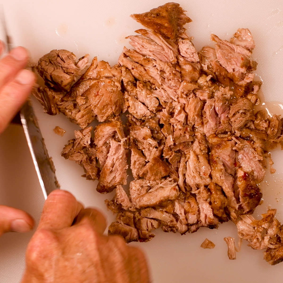 Chop some of the carnitas meat.