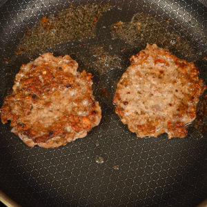 Cook frozen sausage patties in a hot skillet.