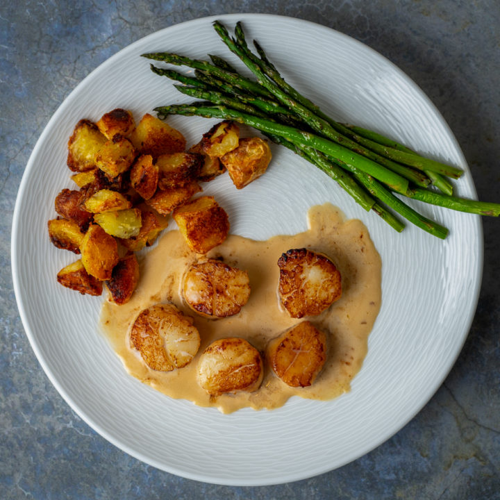 Seared scallops with champagne cream sauce.