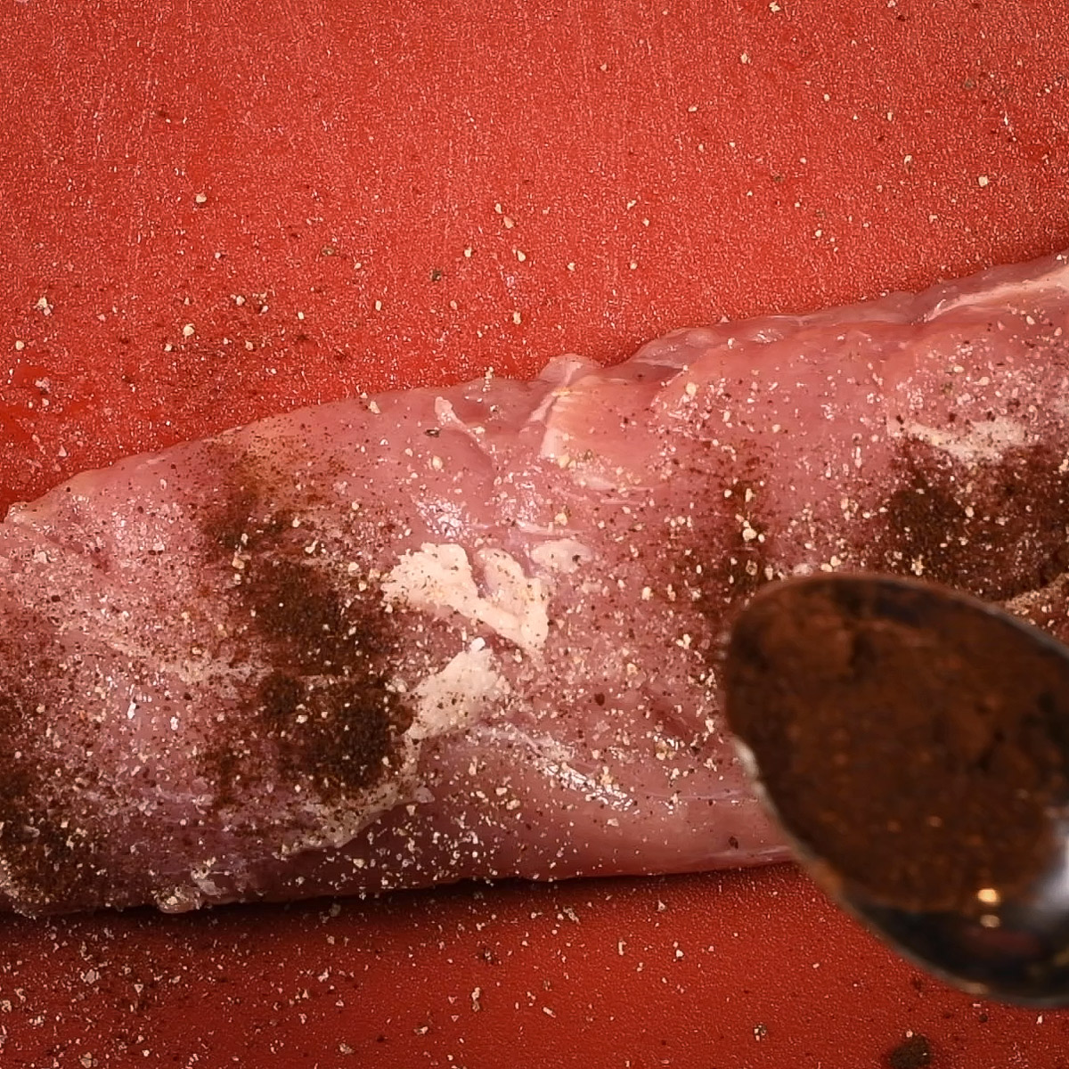 Season the pork tenderloin with kosher salt, freshly ground black pepper and chili powder.