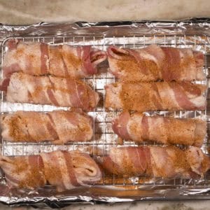 Place the bacon-wrapped stuffed shells on a wire rack and sprinkle with BBQ rub.