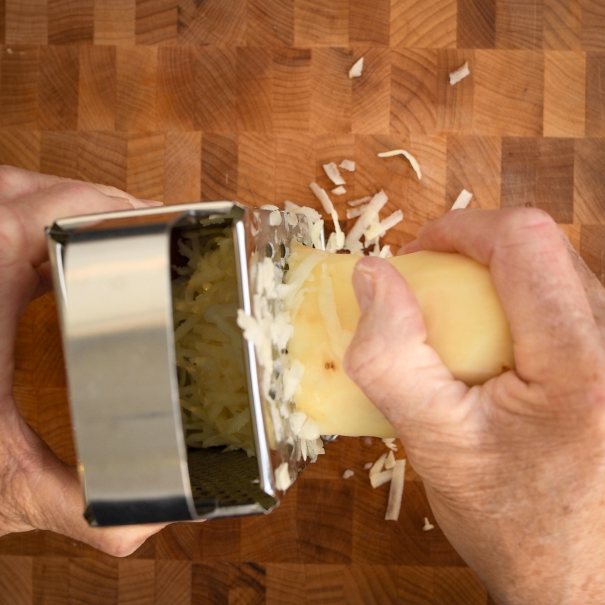 Grate the potatoes using a cheese grater.