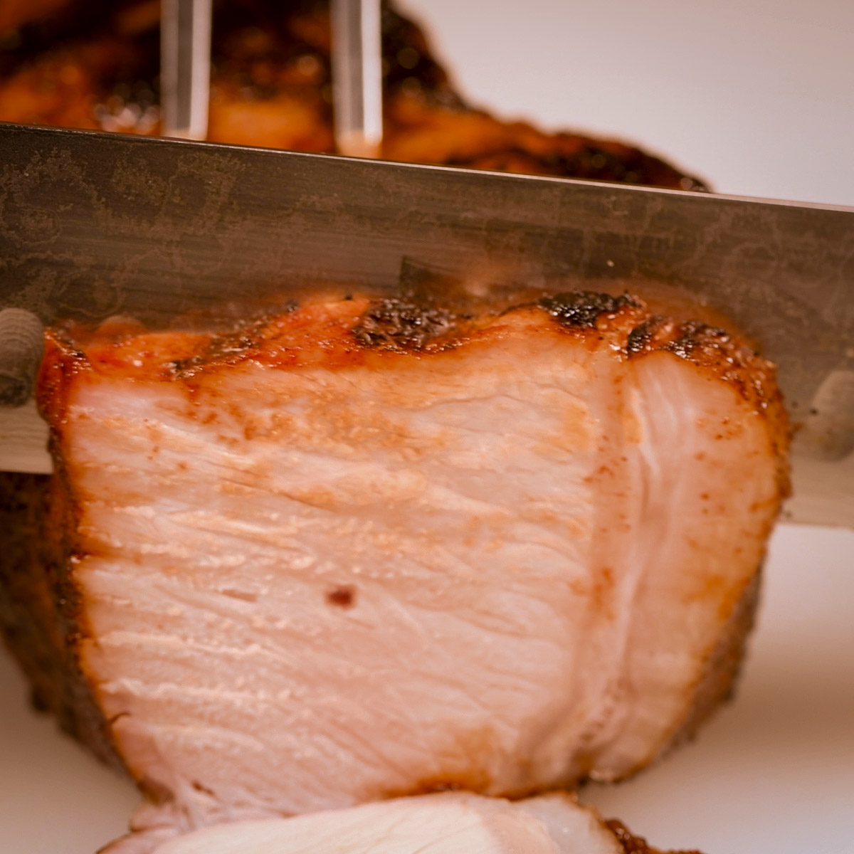 Slicing a cooked pork chop.