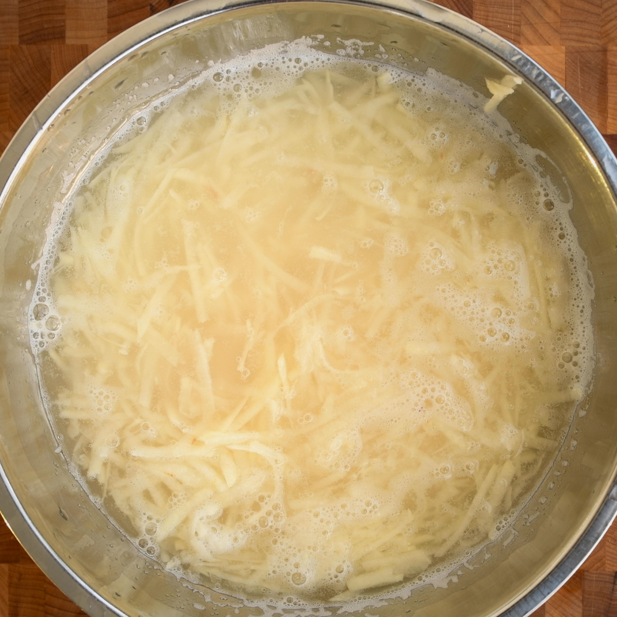 Soak the shredded potatoes in cold water.