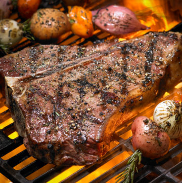 T-bone steak on a hot grill.