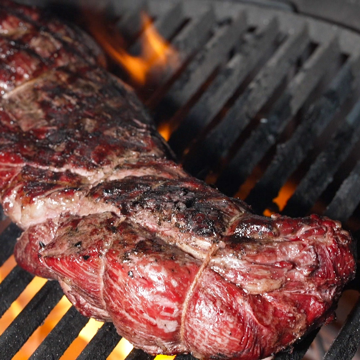 Tenderloin being seared on a hot grill.