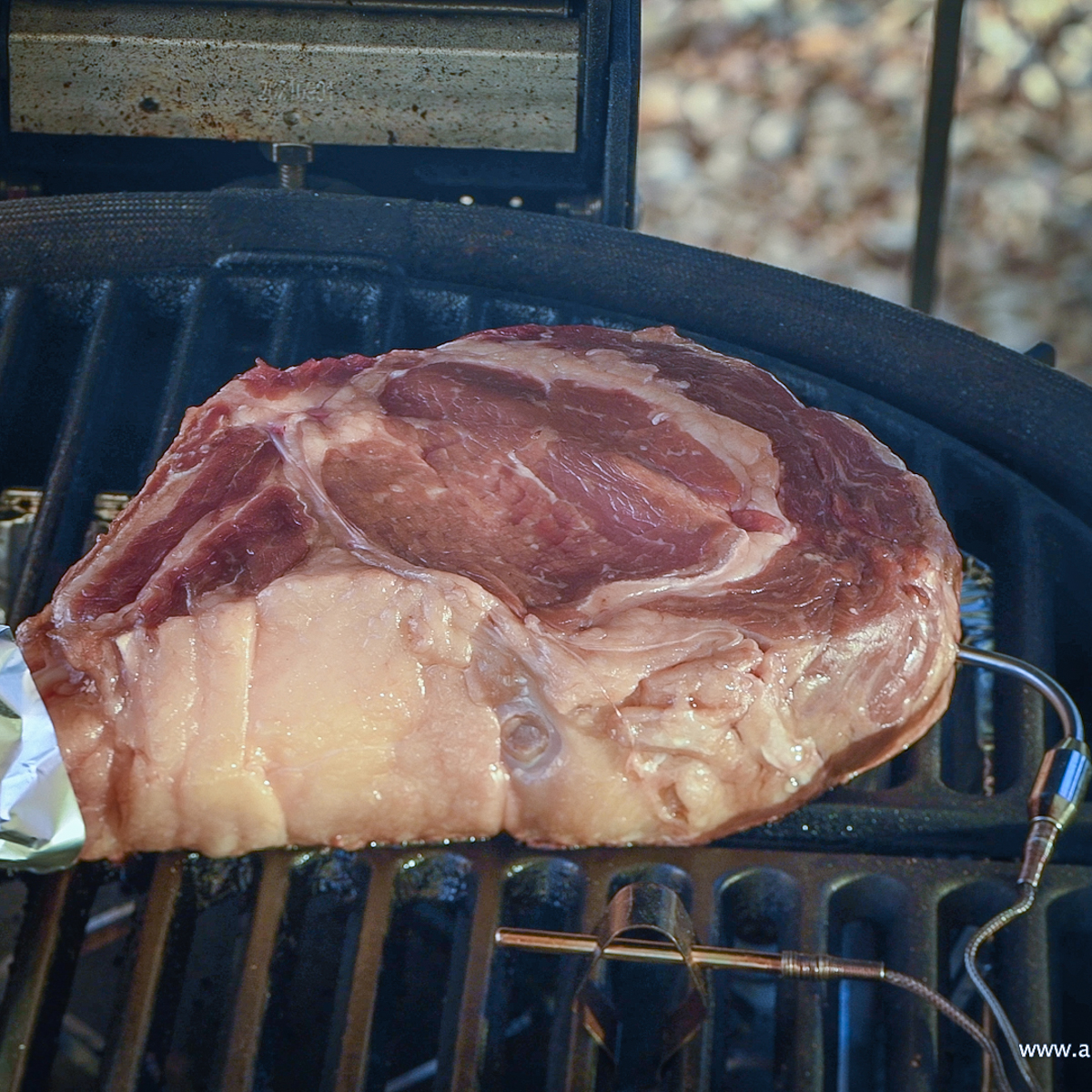 Tomahawk steak inside a Kamado Joe.