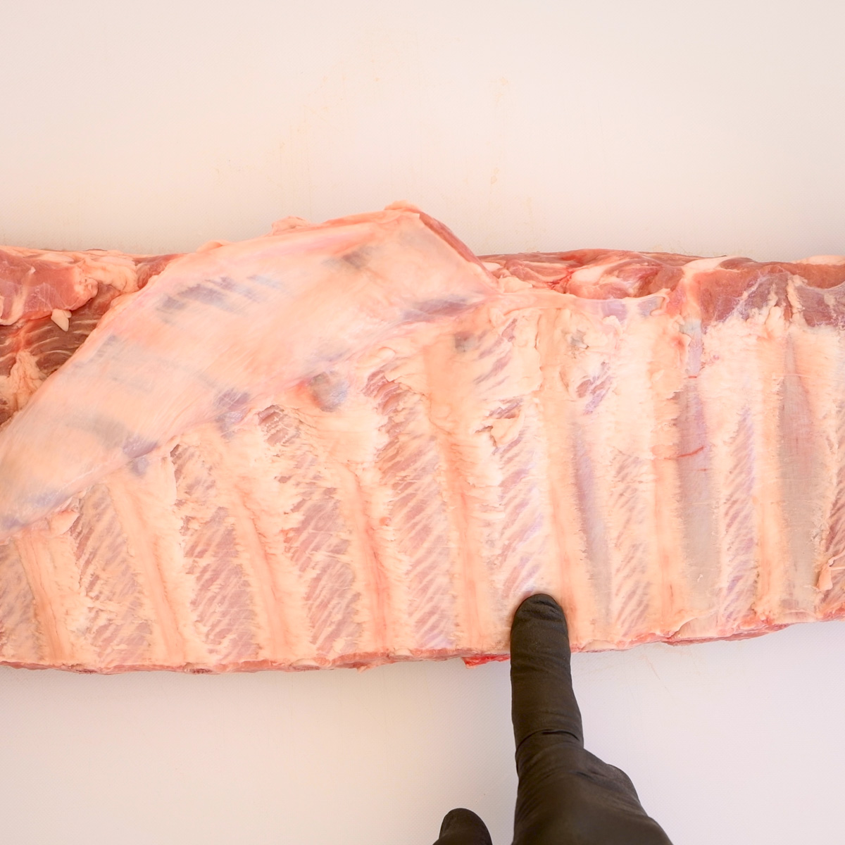 Remove the membrane from the back of the ribs.