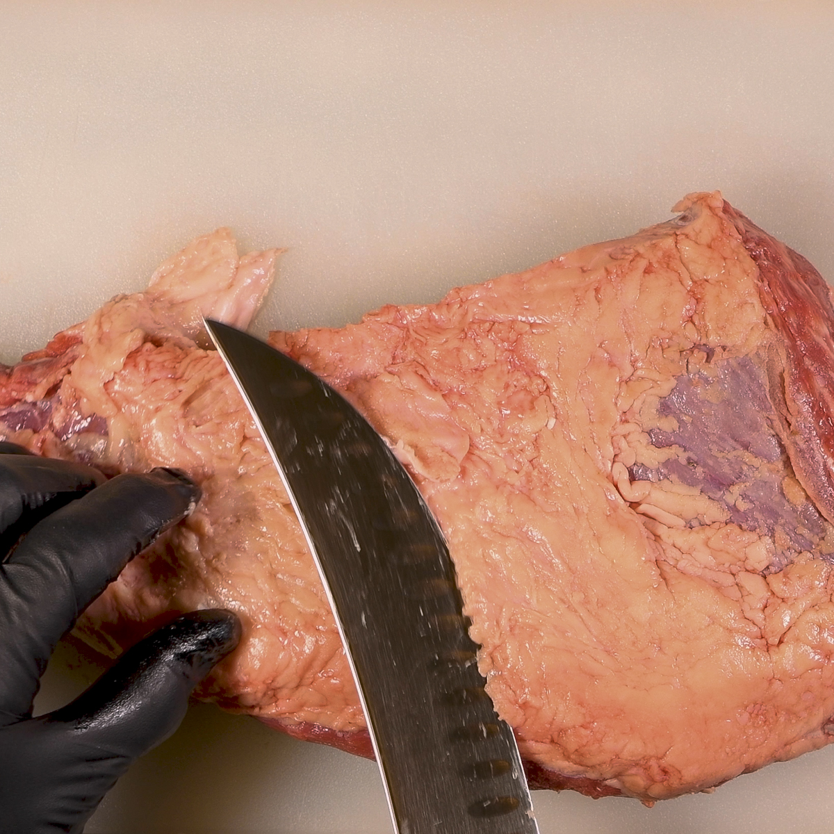 Trim the rubbery fat from the tri-tip.