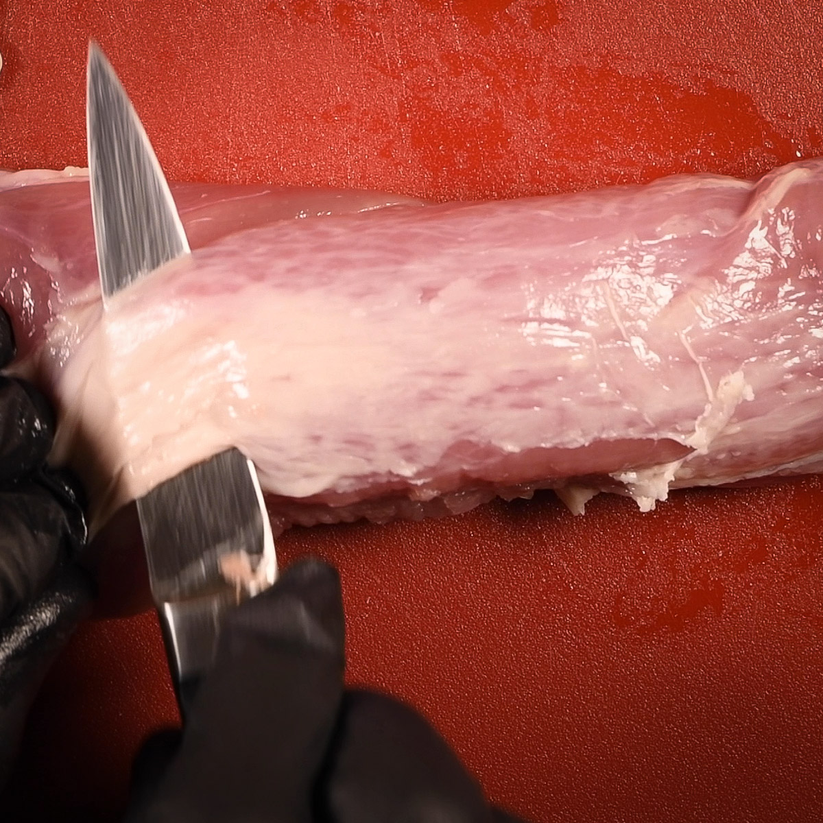Trim the excess fat from the pork tenderloin.